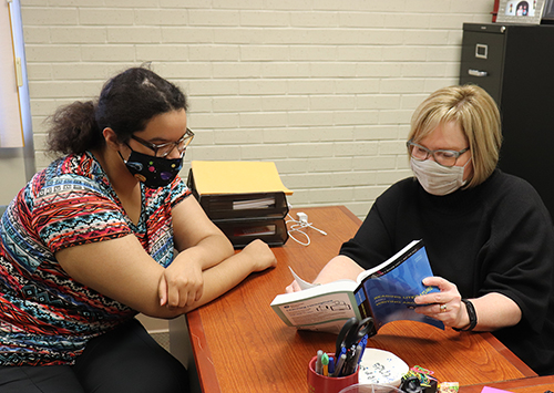 Professor Shottenkirk meets with student LaRessa Wood to discuss her classroom experience.