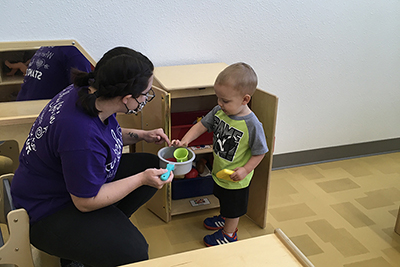 A Redlands student enjoys working with children at a child development center. 