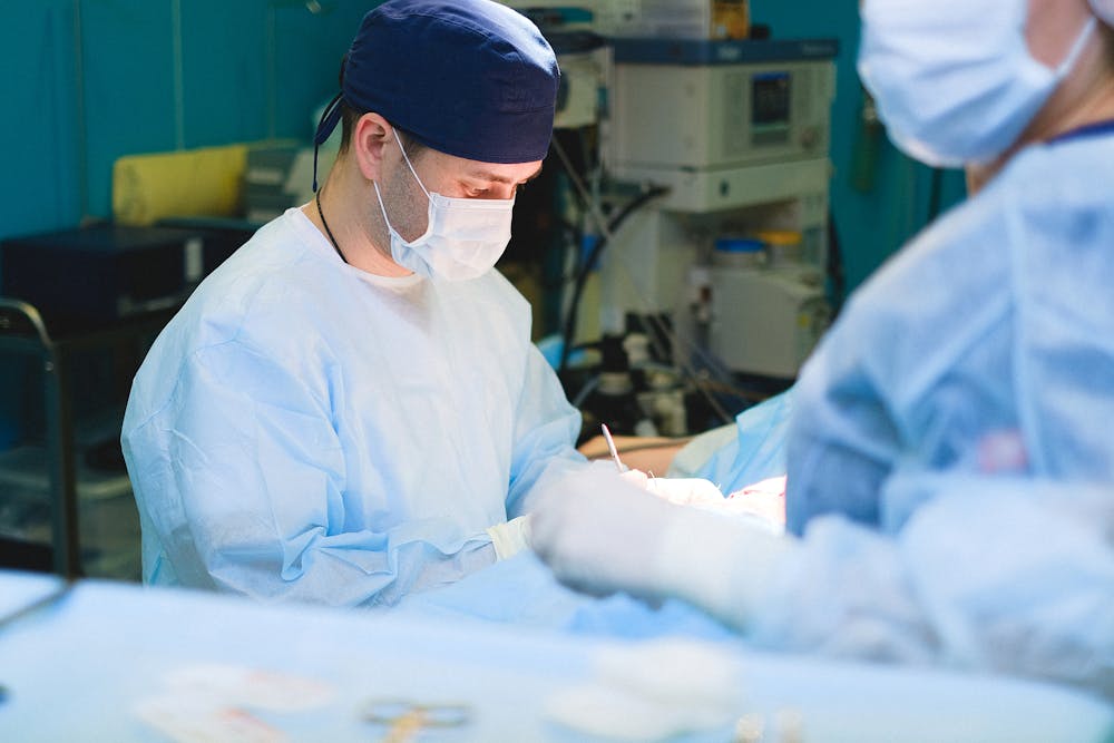 Man in scrubs concentrates in an operating room