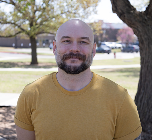 Bearded man wearing yellow shirt