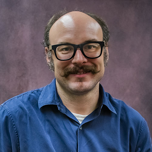 Man with a moustache and glasses