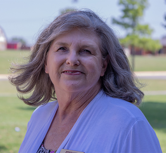Woman in white shirt with wind-tossed hair