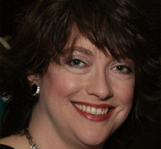 Smiling woman with wavy dark brown hair