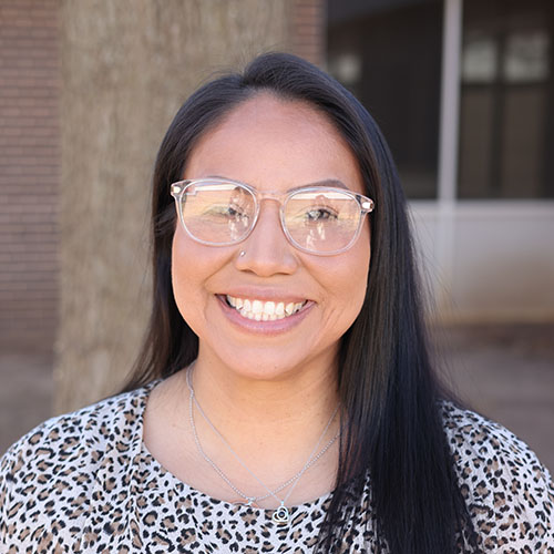 Smiling woman with glasses and straight black hair