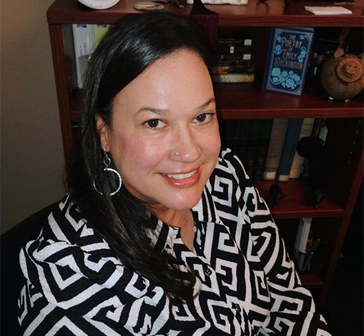 Woman with dark hair and glasses