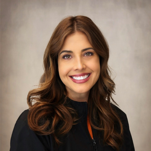 Woman with brown hair wearing a black blouse