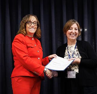 Redlands Community College President Jena Marr, left, congratulates Redlands history professor Bethany Holley-Griffith, winner of the OACC Great Ideas for Teaching (GIFT) Award.