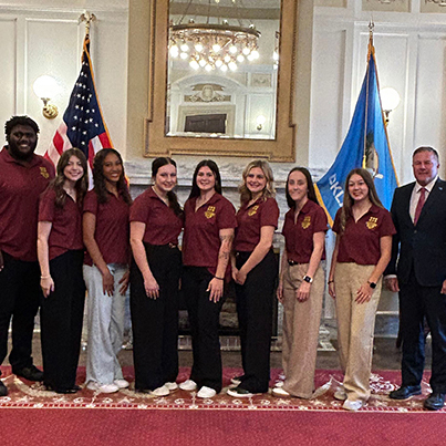 Group of students in the state capitol with a legislator