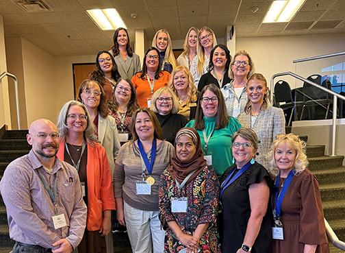 group of employees standing on stairs