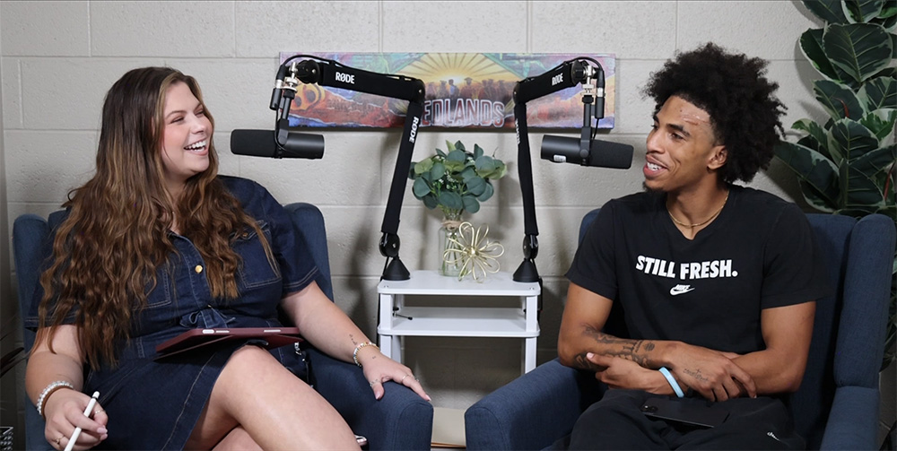Woman laughs while talking to a young man next to her