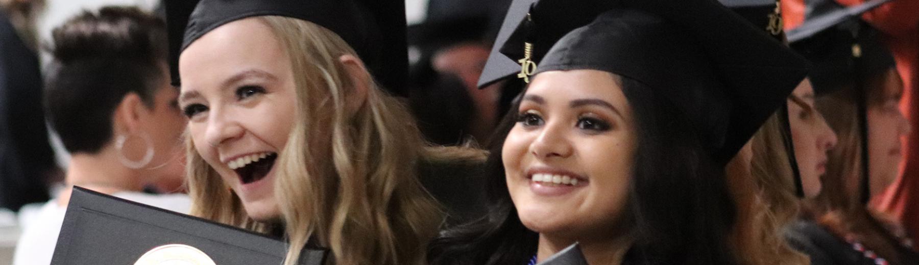 Redlands students smiling at graduation