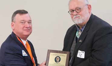 Connors President Ron Ramming presents President Jack Bryant with a plaque. 